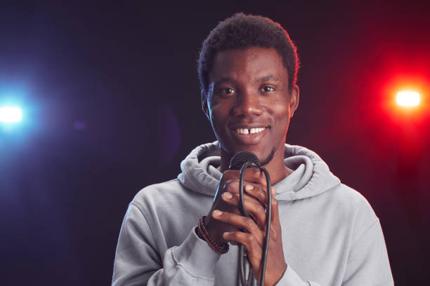 istock Smiling African-American Man Holding Microphone 1287419316