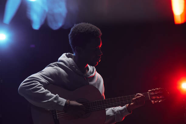 african-american musician playing acoustic guitar on stage - men artist guitarist guitar imagens e fotografias de stock