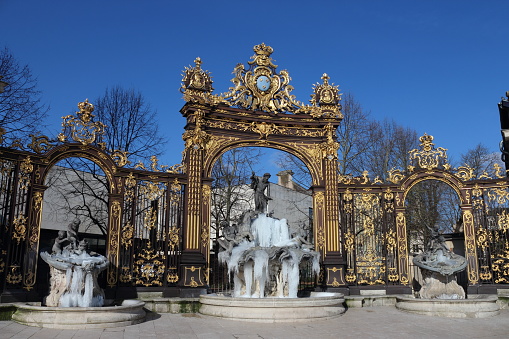 Frozen gilded fountains with satues and decorations on a Place Stanislas in the city of Nancy,France. Winter.