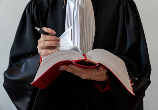 Photo of serious judge wearing black robe hold gavel for verdict isolated grey color background.