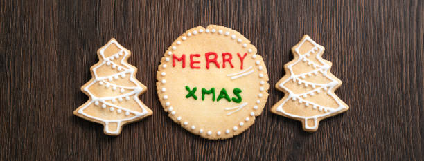 istock Top view of decorated Christmas tree cookie on wooden table background with copy space. 1287421193
