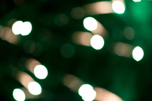 istock Festive background white blurred bokeh spots on green background. 1287421480