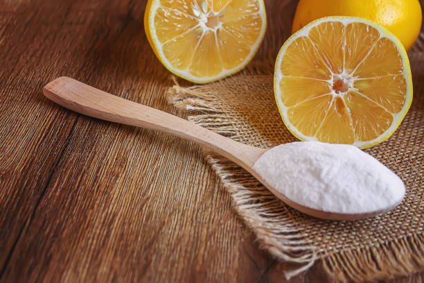 istock Citric acid on a wooden background with lemon. Selective focus. 1287421640
