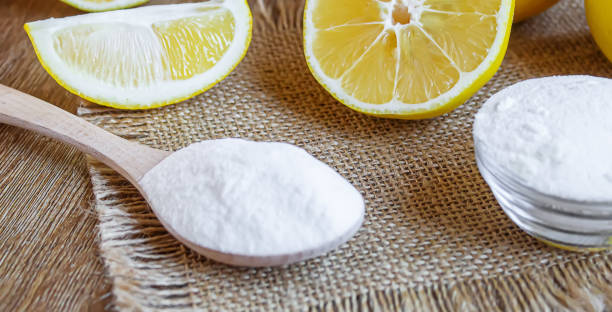 istock Citric acid on a wooden background with lemon. Selective focus. 1287421647