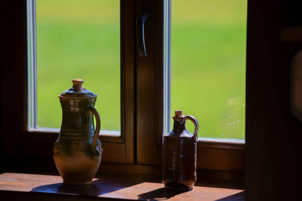 Clay pots are on the window.