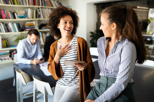 istock Working together on project. Happy young business colleagues working in office 1287422828