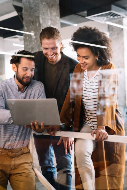 istock Successful company with happy workers. Business, meeting, office concept 1287423014