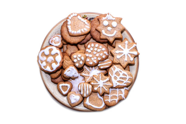 Festive gingerbread cookies decorated with icing. Lots of cookies on the platter. Isolated object.