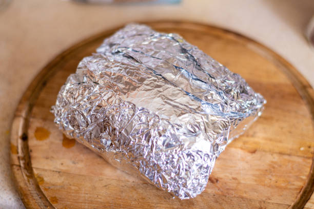 istock Meat in foil. Cooking, roasting pork. 1287423406