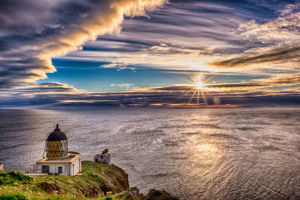 istock St Abbs Head lighthouse with unusual cloud formation and sunrise, Berwickshire, Scotland, Britain 1287424156