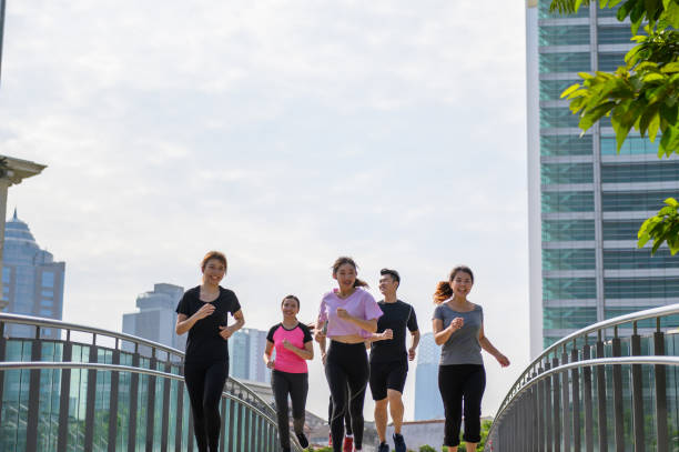 istock Group of young asian jogging through city park 1287424493