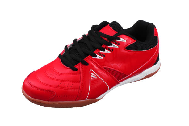 istock Red sneakers with black laces and white stripes on a white background. 1287424703