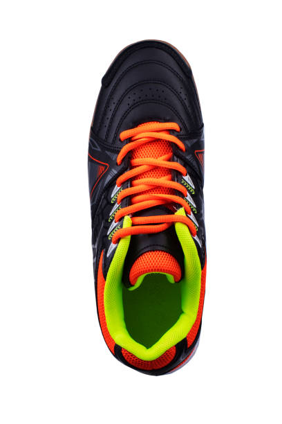 istock Black sneaker with orange laces and stripes. 1287424876