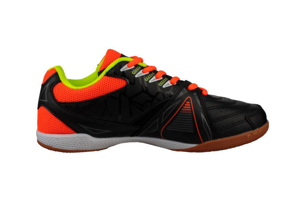 istock Black sneaker with orange laces and stripes. 1287425545