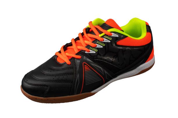 istock Black sneaker with orange laces and stripes. 1287425629