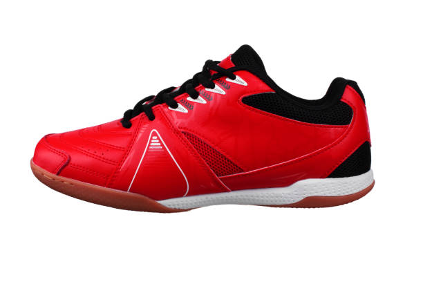 istock Red sneakers with black laces and white stripes on a white background. 1287425757