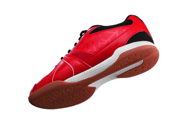 istock Red sneakers with black laces and white stripes on a white background. 1287425769