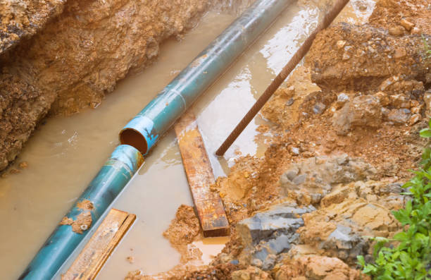 istock repair the plumbing broken pipe and water flow in hole 1287426593