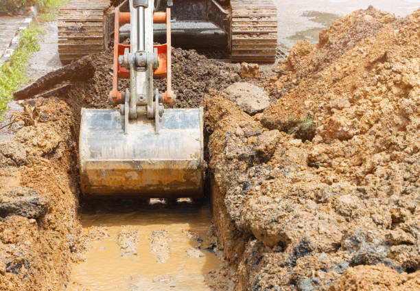 istock backhoe dig repair broken water line pipe main plumbing on road 1287426627