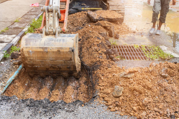 istock backhoe dig repair broken water line pipe main plumbing on road 1287426666