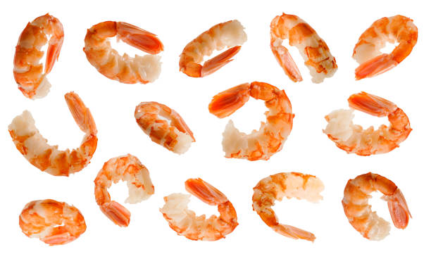 istock Big cooked peeled shrimps at various angles on white background 1287427684