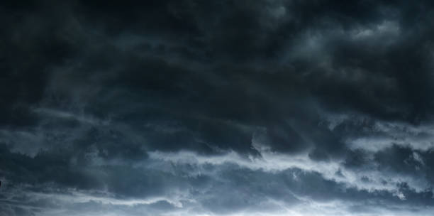 istock The typhoon, tornado in a stormy dark sky with black clouds and a strong wind. Panoramic image. 1287428956