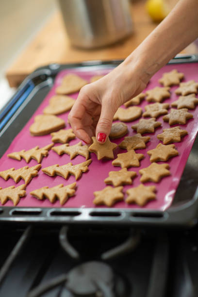 istock Placing holiday shaped cookies on a baking tray 1287429216