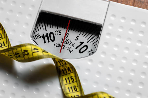 istock floor scales and measuring tape close up 1287429551