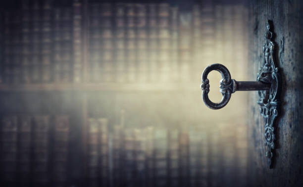 istock Old key in keyhole, macro shot. Gothic style. 1287429599