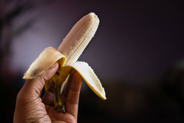 160+ Human Hand Holding Peeled Banana Stock Photos, Pictures & Royalty ...