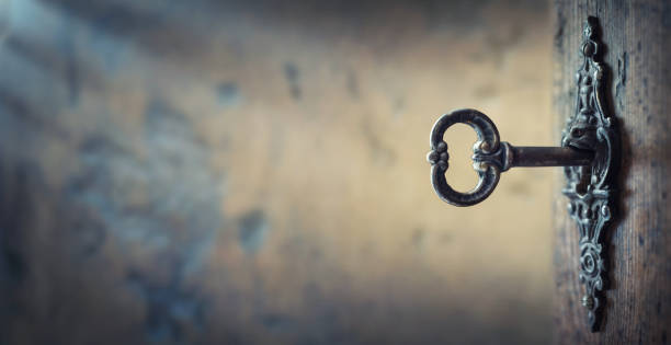 istock Old key in keyhole, macro shot. Gothic style. 1287429687