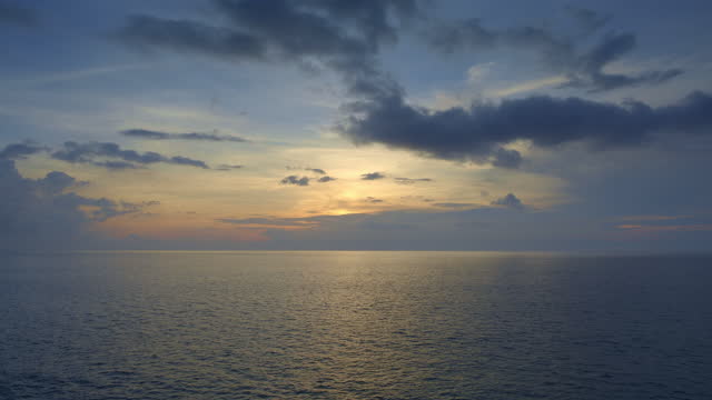 Beautiful dramatic sunset with dark blue and yellow sky in indian ocean