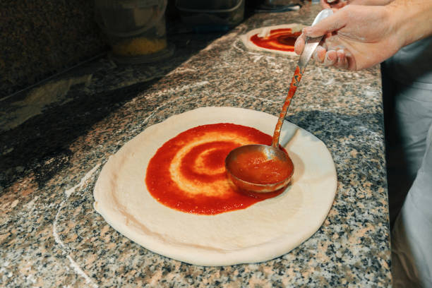 foto de preparo de pizza crua fresca no estilo tradicional. conceito de comida italiana - pizza sauces chef making - fotografias e filmes do acervo