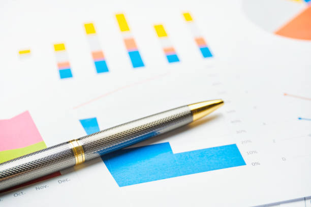 istock Stylish business pen on paper charts and reports 1287431917