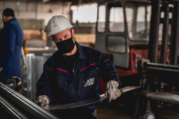 istock Hardworking man in factory workshop working during epidemic 1287432381