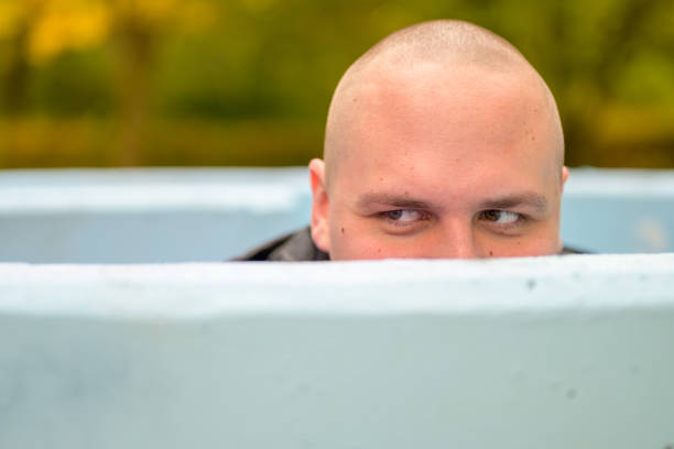 istock Young man hunkering down in an outdoor tub or pool 1287432613