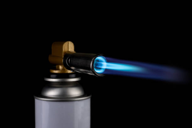 istock Flamethrower burner gas blow torch Ignition with blue fire flame at black background 1287432894