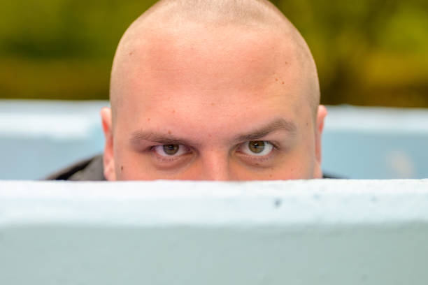 istock Young man hunkering down in an outdoor tub or pool 1287433452
