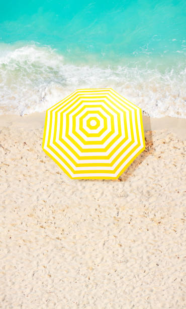 istock Beach umbrella on the sand near ocean surf waves 1287433526