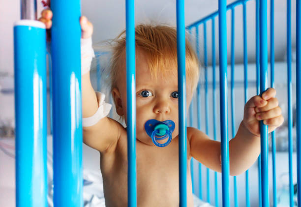 sad kid looks over the fence. foreground