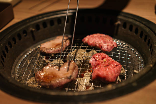 istock Yakiniku - Grilling meat at a yakiniku restaurant 1287435211