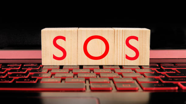 istock wooden blocks with SOS text on laptop keyboard, business concept 1287435337