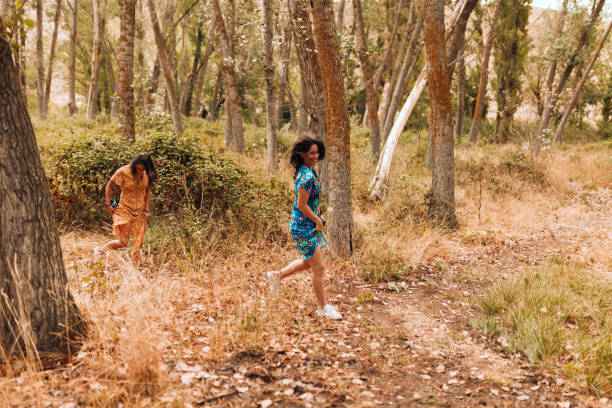 istock Two young lesbians walking in the woods wearing long dresses 1287436936