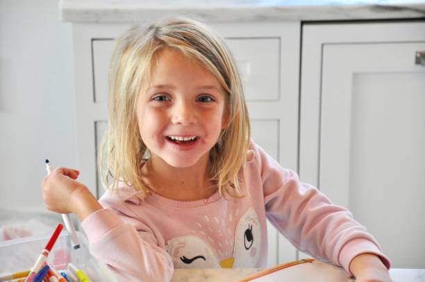 istock Young Girl doing homework at kitchen counter 1287437284