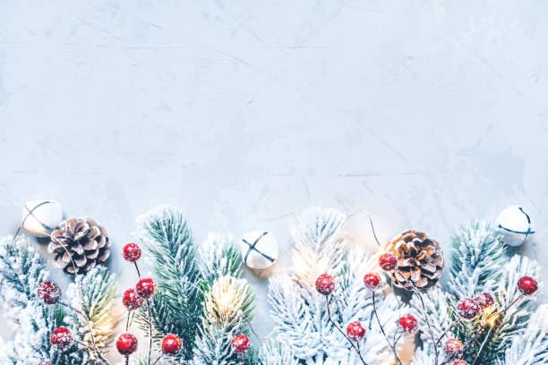 istock Christmas background of snow-covered branches with berries. 1287438243