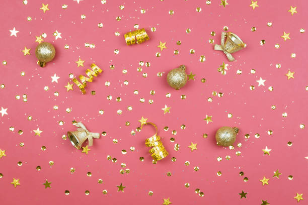 istock Coral background with glitter, golden stars and decorations. Sparkling texture. Festive backdrop for your projects 1287438336