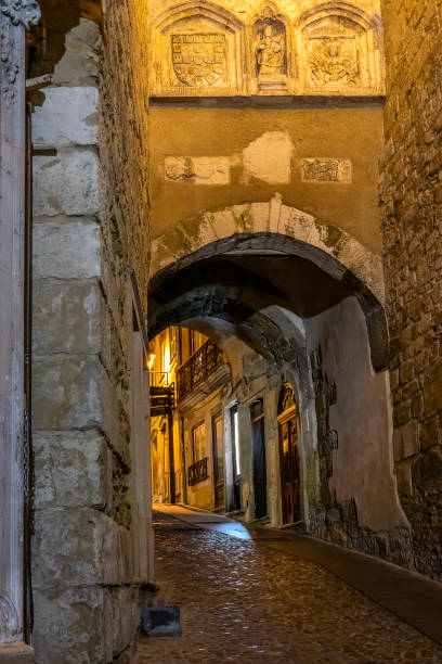 Coimbra, Portugal. Arch Medina Coimbra city at night, detail of an old street.  Arch of Almedina. coimbra city stock pictures, royalty-free photos & images