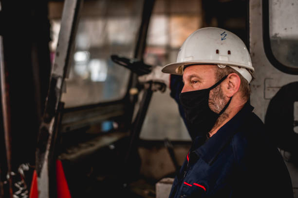 istock Mature man in factory workshop working alone during epidemic 1287439104