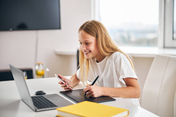 istock Pleased young artist working on a digitizer 1287439186