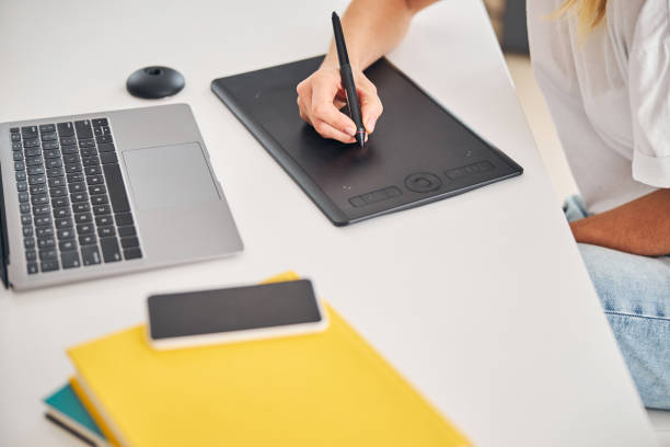 istock Female artist using a gadget for creating digital drawings 1287439258